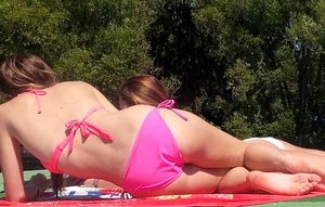 Sexy blonde up close in pink bikini with friend