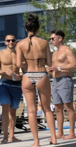 Fit brunette spotted at the pool in a cheeky bikini