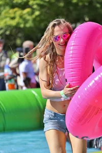 Tubing hottie in shorts and a wet white shirt