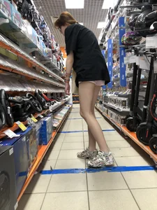 Tall Skinny Girl in Shorts and Sneakers With Long Thin Legs at a Store Creepshots Collection