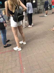 Hot Candid Girl in a Top, Shorts and Sneakers Skinny Legs Closeup Creepshots Gallery on the City Street