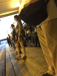 Cute Teen in Shorts on the Tram Stop