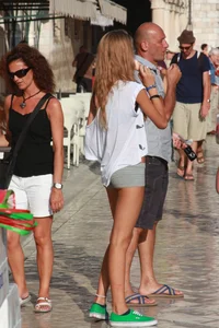 Sexy skinny blonde eating ice cream in short tight grey shorts