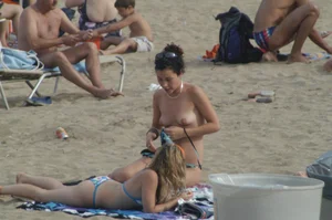 Topless girls on a beach in Barcelona