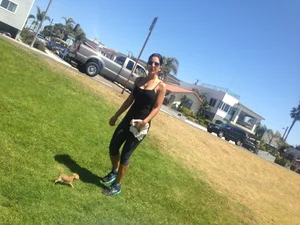 Hot brunette babe in leggings walking her dog with a nice ass and some cleavage