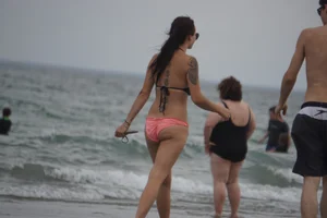 Peach bikini tattood babe on the beach with a nice ass and some camel toe
