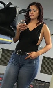 Thick brunette in tight jeans and showing some side boob