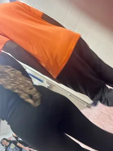 College teen wearing tight pants walking down the hall