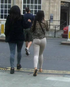 Brunette lady with a nice ass in light grey leggings walking
