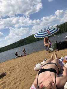 Cute Candid Girl Lying on Sand by the Lake