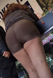 Latina in headshop looks at cam and bends over