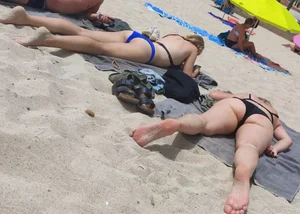 Milfs and girls resting at the beach in sexy bikinis