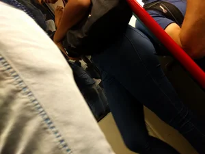 Train girl in tight jeans with a nice ass standing around