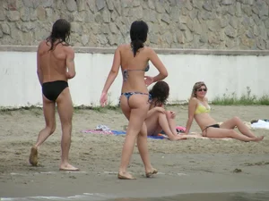 Sexy girl in a blue floral thong bikini at the beach