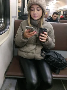 Girl in Leather Leggigns Sitting in a Public Train