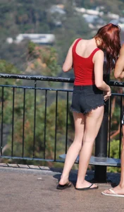 Redhead beauty in short shorts showing some cheeks and panties