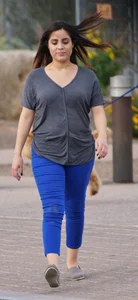 Sexy dog walker in shorts and tank top with friend in blue jeans
