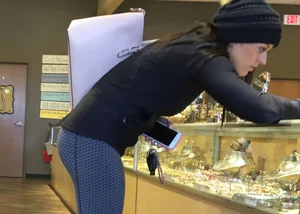 Brunette jewelry shopping in leggings with a nice ass