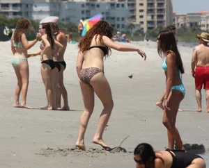 Brunette and redhead on the beach in bikinis looking sexy
