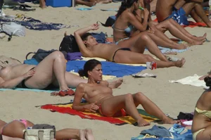 Topless girls on a beach in Barcelona