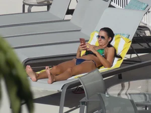 Hot milf sunbathing in a thong by pool and swimming
