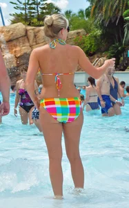 Blonde milf with a sexy body in bikini at the pool