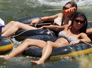 Sexy party girls in bikinis on a lake