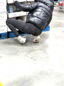 Girl in leggings with a perfect ass and slim legs picking flowers at the supermarket creepshots
