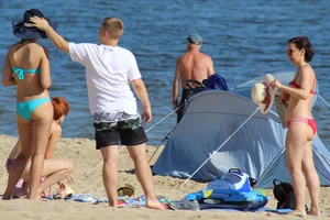 Couple of hot babes hanging out at the beach in bikinis