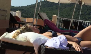 Blonde laying out in a blue bikini with a sexy body