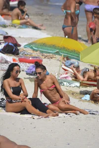 Sexy beach babe in pink bikini makes it a string bikini