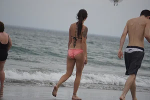 Peach bikini tattood babe on the beach with a nice ass and some camel toe