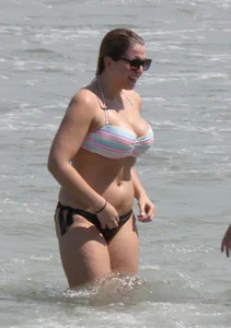 Big boobed thick blonde on the beach in a bikini