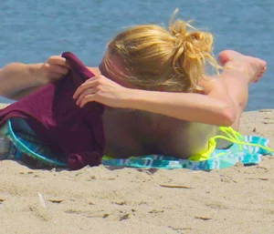 Sexy ass blonde milf on the beach in a thong with cameltoe and bending over