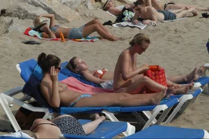 Girls on a nude beach in Sitges, Spain