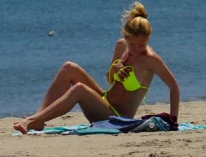 Sexy ass blonde milf on the beach in a thong with cameltoe and bending over