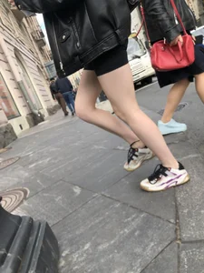 Very hot legs of a candid girl wearing a leather jacket