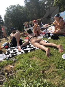 Amazing chick in a swimsuit laying on grass in a park