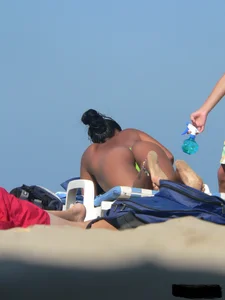 Hot ass topless beach girl with great tits lets her little brother oil up her ass in thong bikini