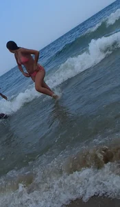 Pierced nipples hottie in pink at the beach