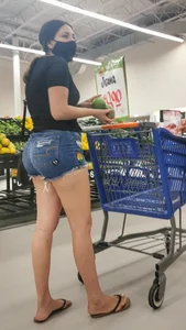 Big booty in jean shorts and nice legs, supermarket girl in a mask
