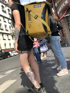 Amazing cute candid food delivery girl with lots of tattoos crossing the street