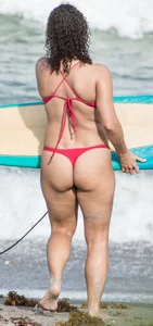 Thick brunette milf on the beach in red thong bikini