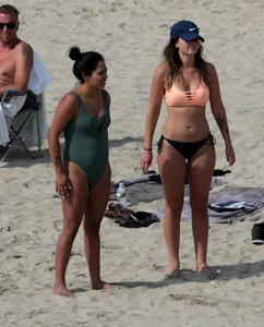 Big boobed babe with pokies in a bikini on the beach with friends