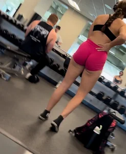 Bend over at gym in red shorts