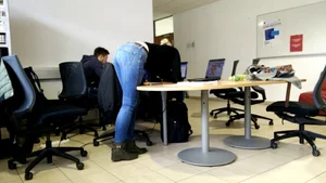 Co-worker bent over table during meeting break