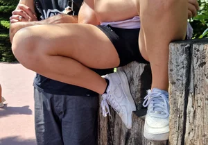 Amazing photo of a candid teen wearing shorts perched ona pole spreading her legs