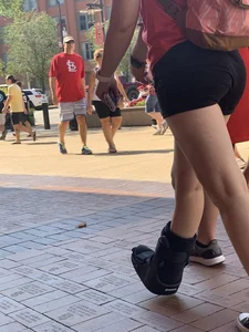 Bunch of girls in various outfits at a Cardinals baseball game