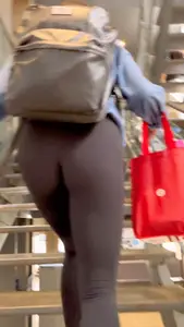 College girl going up the stairs with leggings and pink crocs