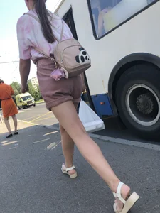 Young Girl in Sandals and Shorts in a Public Bus